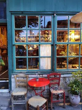 Cafe bar windows door table chairs in the evening in ioannina city greece Stock Photos
