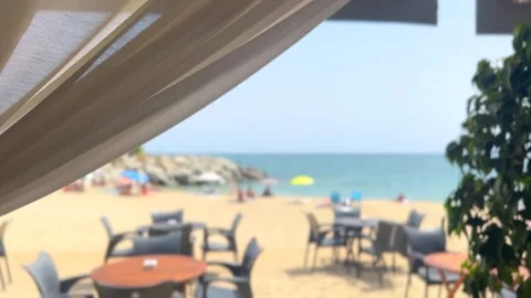 Cafe on the beach, seaside outdoor beach restaurant blurred background, terrace  Stock Footage 340326699