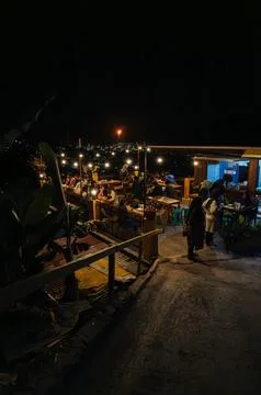 A Cafe built on a platform at the top of the hill at night. Stock Photos