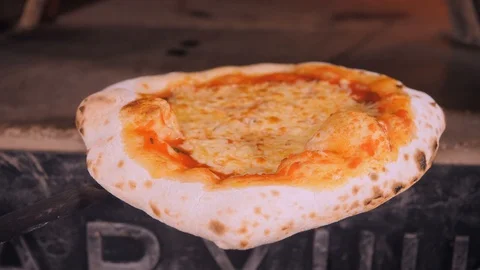 Cafe chef holds baked crispy pizza with melted cheese Stock Footage 126951979