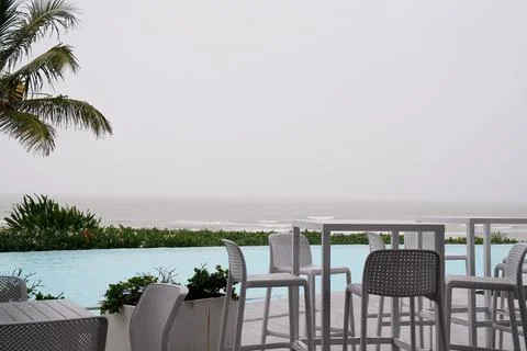 Cafe Dining By The Oceanside Pool On A Rainy Day Stock Photos