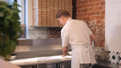Cafe employee puts dough on table and sprinkles flour Stock-Footage 127214943
