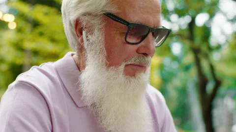 At the cafe good looking old man working at the laptop typing something Stock Footage 164729138