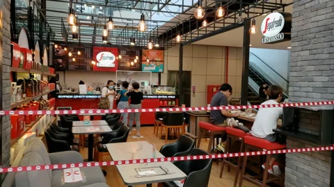 Cafe has Social Distancing Measures in Place With Blocked off Chairs and Tables Stock Footage 130666420