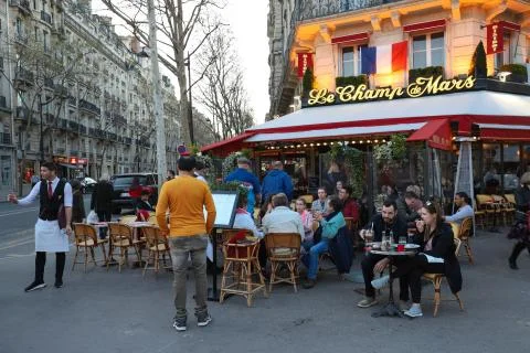 Cafe Le Champ de Mars is traditonal French cafe located near the Eiffel tower Stock Photos