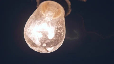 Cafe light fillament bulb on a string above patio yard at night Video stock 89144114