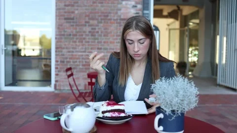 Cafe manager records notes about dessert quality during daily work Stock Footage 345028335