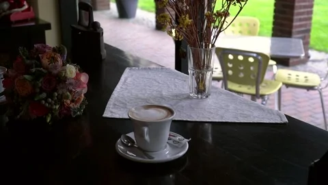 In a cafe, not at the table, two cups of coffee and a wedding bouquet Stock Footage 86604287