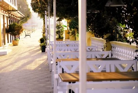 Cafe in the open air. Seafront. Early in the morning.Fog. Spring Stock Photos