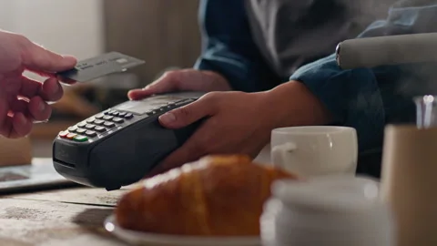 Cafe, operator confidently paying online with credit bank card in coffee sho 스톡 동영상 249103358