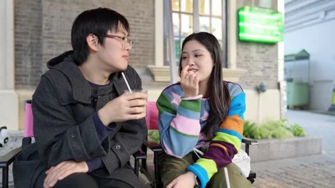 A cafe on a public road where many people walk in Shanghai, China. A young Stock Footage 301449457