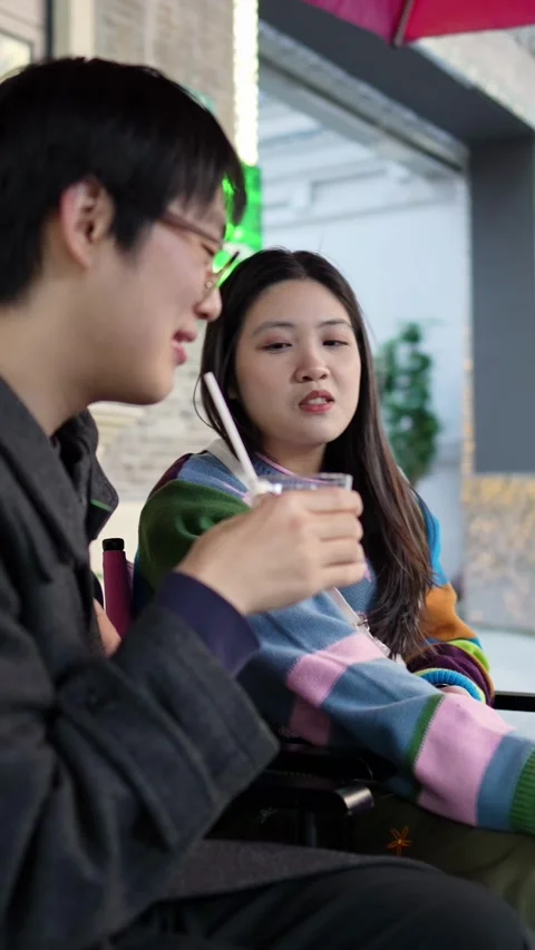 A cafe on a public road where many people walk in Shanghai, China. A young Stock Footage 301663836
