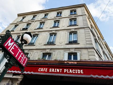 Cafe Saint Placide storefront with classic metro sign under Haussmann style.. Stock Photos