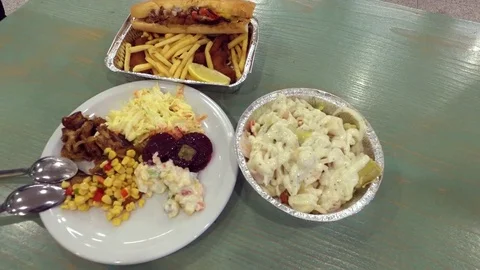In the cafe. Salads, fried potatoes, fish in batter. Stock Footage 77218934