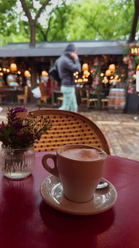Cafe Scene with Coffee Cup and Charming Outdoor Setting Stock Footage 318554547
