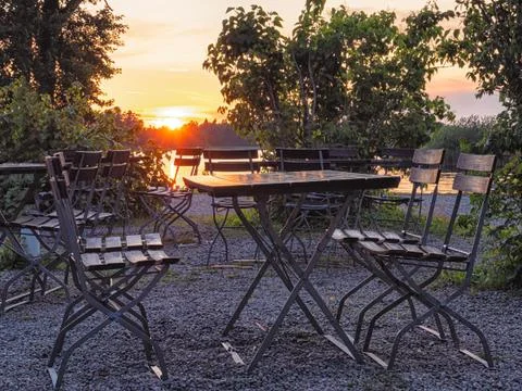 Cafe table near the lake at evening, focus on table Stock Photos