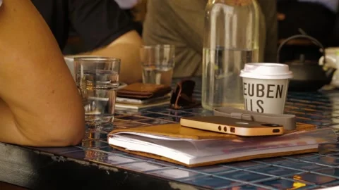 Cafe Table Scene With People, Drinks, and Notebooks in Sydney, Australia Stock Footage 345692059