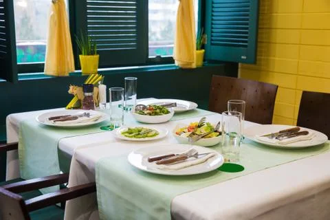 Cafe, table setting, yellow and green color Stock Photos