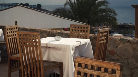 Cafe with tables and chairs in the open air along the Red Sea at the tourist Stock Footage 100648227
