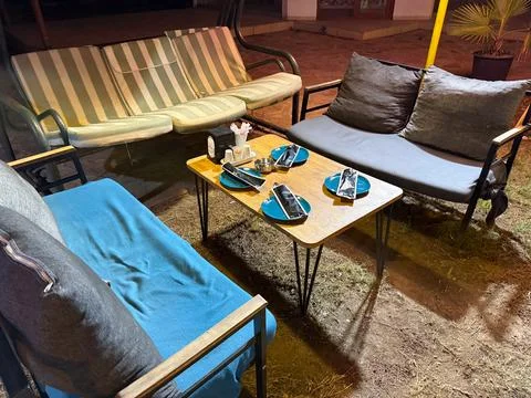 Cafe terrace with sofas and table set for guests in the evening. Hospitality, Stock Photos