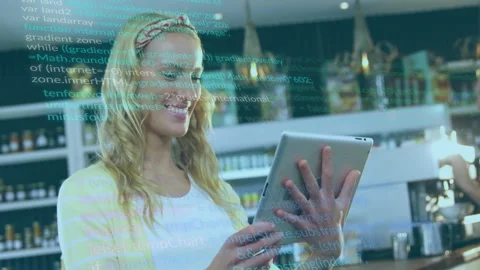 In cafe, woman using tablet with animation of computer code overlay Stock Footage 306251741
