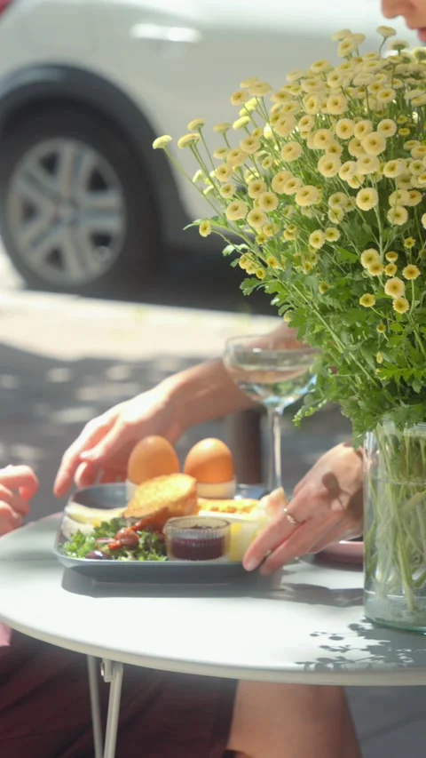 Cafe Worker Arranging Danish Breakfast and Wine Glass on Outdoor Table Stock Footage 339275522