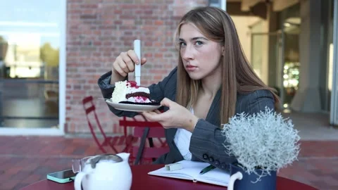 Cafe worker checks cake quality and records observations during her shift Stock-Footage 345028365
