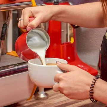 Cafe worker making coffee on professional coffee maker close up, can be backg Stock Photos