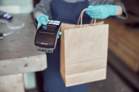 Cafe worker offering contactless payment machine indoors Stock Photos