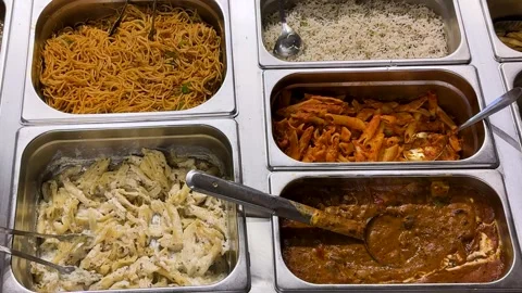 Cafeteria buffet selection showcasing freshly cooked noodles pasta and curr.. Stock Footage 336981347