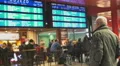 Cafeteria in the waiting room, old man with eyeglasses looking at train schedule HD Footage