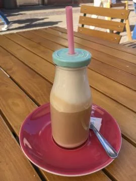 Caffe Latte in a glas bottle Stock Photos
