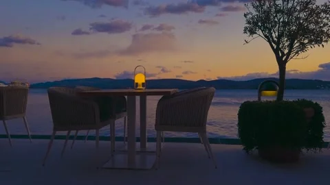 Caffe table sea view with yellow sunset landscape Stock Footage 237536237