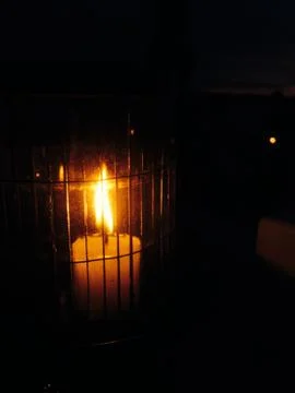 Caged candle at night Foto stock