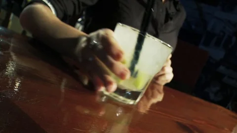 Caipiroska coktail. The bartender moves the cocktail to the counter. Stock Footage 80309566