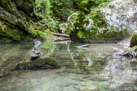 A cairn in the middle of a stream Stock Photos