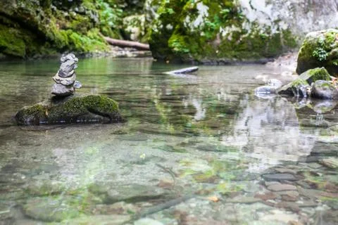 A cairn in the middle of a stream Stock Photos