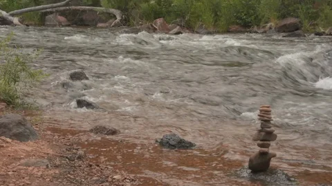 Cairn rock formation on the side of the river, water flows through. Stock Footage 95165803