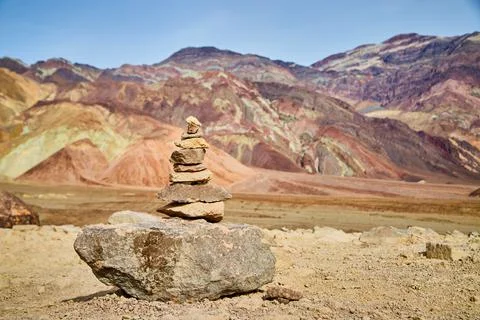Cairn stack of rocks in Death Valley Artists Drive with colorful mountains 스톡 사진