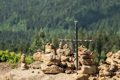 Cairn on a summit with a cross Stock Photos