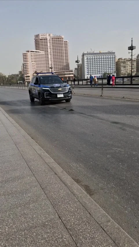 Cairo, Egypt- 12232024 -The main boulevard of Cairo and passing police car Stock Footage 306039962
