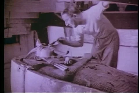 CAIRO, EGYPT, 1922, Howard Carter working on King Tut coffin, photograph Stock Footage 10740423