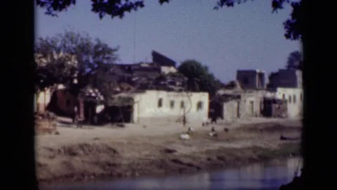CAIRO EGYPT-1946: Waterfront Property Palm Trees Windy Damaged Property People Stock Footage 122714331