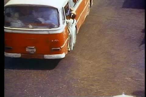 CAIRO, EGYPT, 1977, Bus moving, people hanging out, traffic, Tahrir Square Stock Footage 10737772
