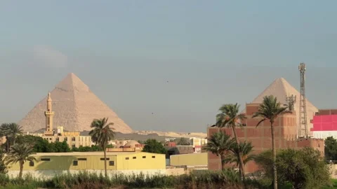 Cairo, Egypt - October 1, 2025: View of the Pyramids of Giza behind residential Stock Footage 340868553