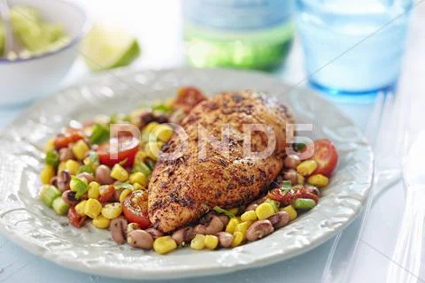 Cajun chicken with a summer sweetcorn salad Stock Photos