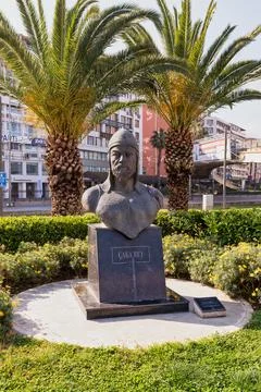 Caka Bey statue, a historical bust surrounded by palm trees and city buildings Stock Photos