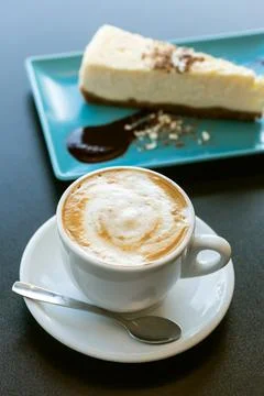 Cake and cappuccino coffee on the table Stock Photos