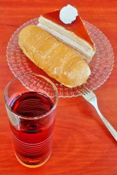 Cake and eclairs on table Stock Photos