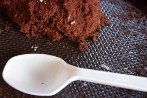 Cake and plastic spoon Stock Photos
